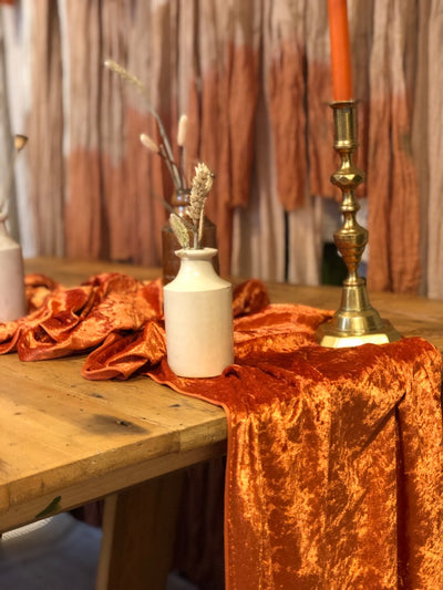 Table runner in burnt orange crushed velvet for hire by Rock the Day | prop hire | table and chair decor hire | event hire Essex, London, Hertfordshire