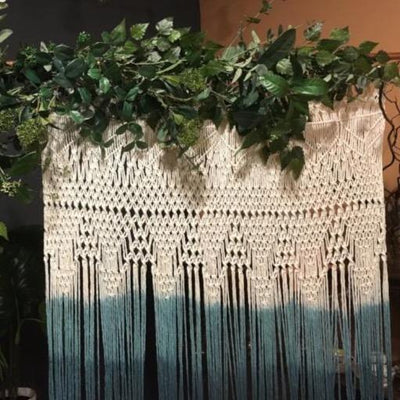 Handmade dip dyed green macrame backdrop for hire | macrame for hire Essex. Photo backdrop, party hire.