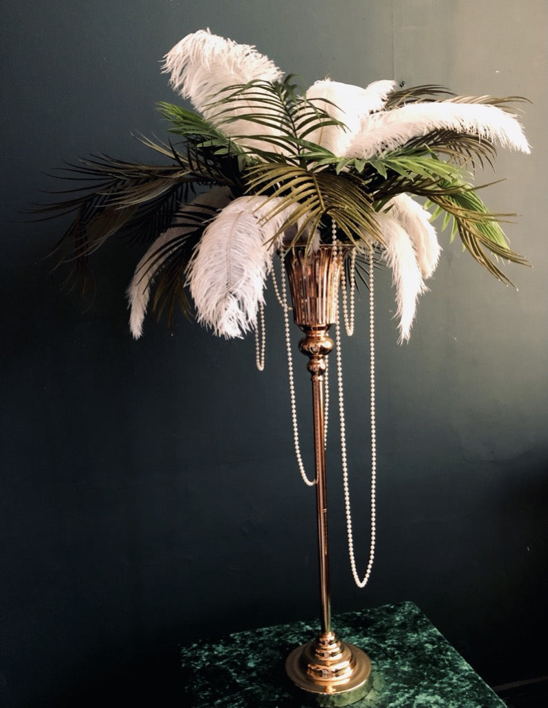 Great Gatsby style gold stands with palm leaves feathers and pearls